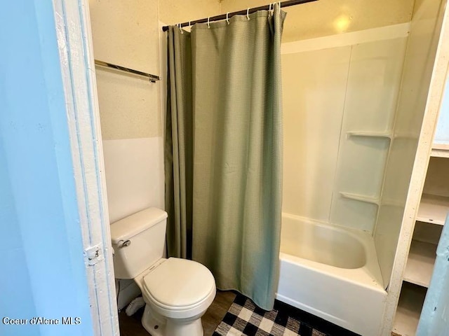 full bath featuring toilet and shower / bath combination with curtain