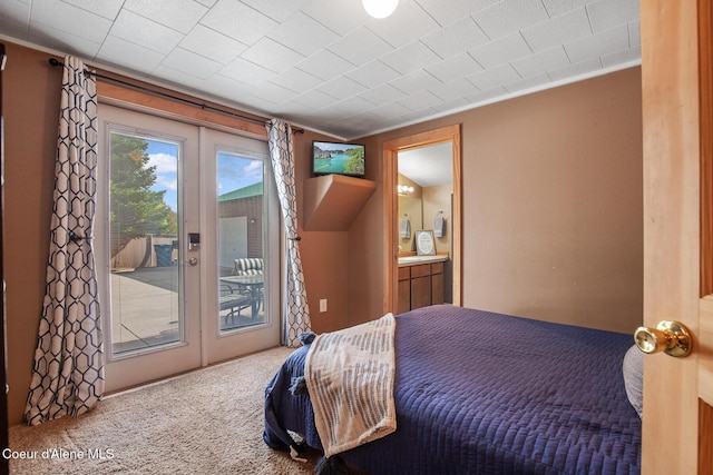 carpeted bedroom featuring connected bathroom and access to outside