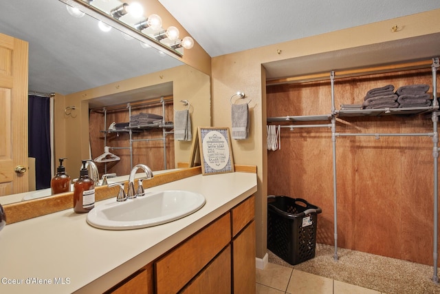 bathroom with tile patterned flooring and vanity