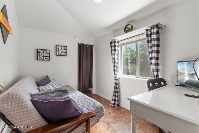 bedroom featuring vaulted ceiling and baseboards