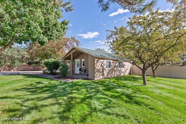 exterior space with a patio area, a lawn, and fence