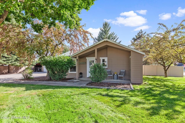 view of front of property with a front yard and fence