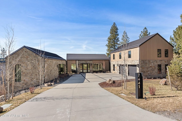 7441 S Buckrail Rd, Harrison, ID 83833 - view of front of house with stone siding, driveway, and an attached garage