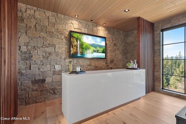 bar with wooden ceiling and hardwood / wood-style flooring