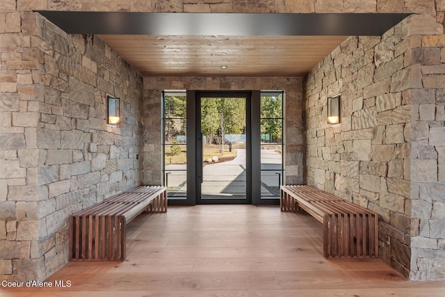 doorway with a sauna, wood ceiling, and wood finished floors