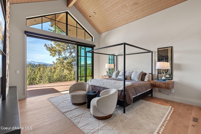 bedroom with beam ceiling, high vaulted ceiling, hardwood / wood-style floors, baseboards, and wood ceiling