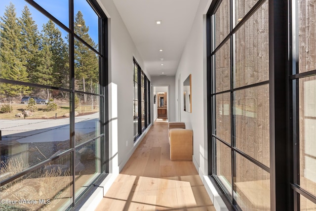 corridor with recessed lighting and wood finished floors