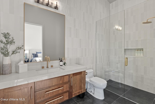 bathroom with tile patterned floors, connected bathroom, tiled shower, and toilet