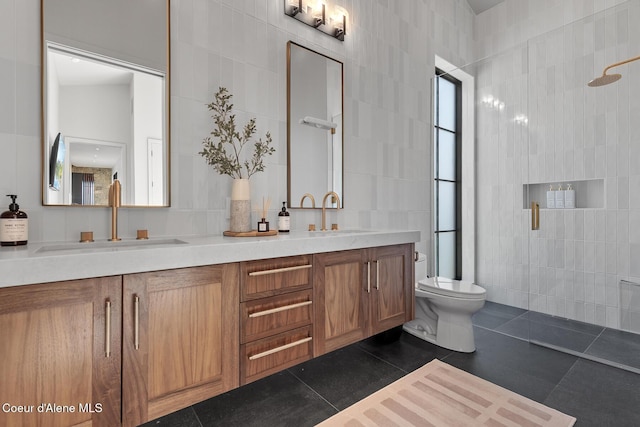 full bath with a sink, a walk in shower, tile walls, and tile patterned flooring