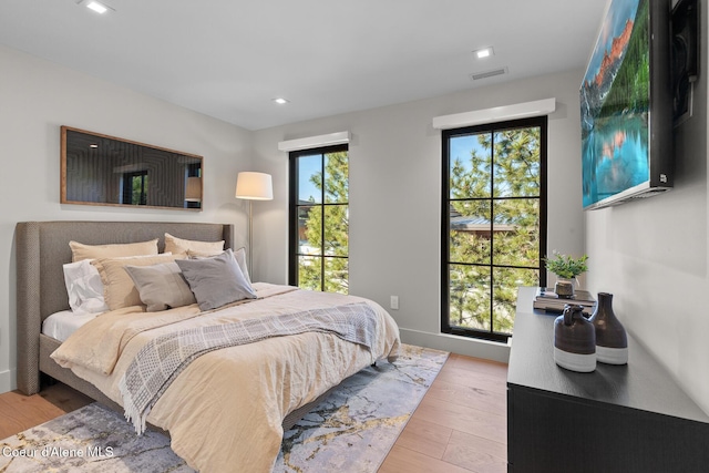 bedroom with recessed lighting, visible vents, and light wood-style flooring