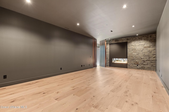 unfurnished room featuring recessed lighting, baseboards, wood finished floors, and vaulted ceiling