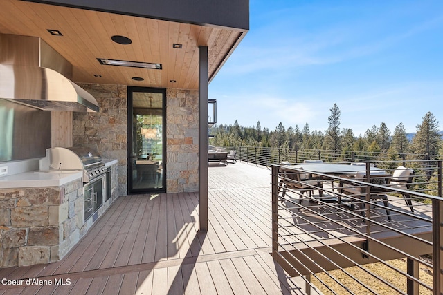 wooden terrace with area for grilling and a grill