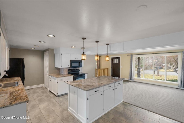 kitchen featuring a kitchen island, white cabinets, black appliances, and a sink