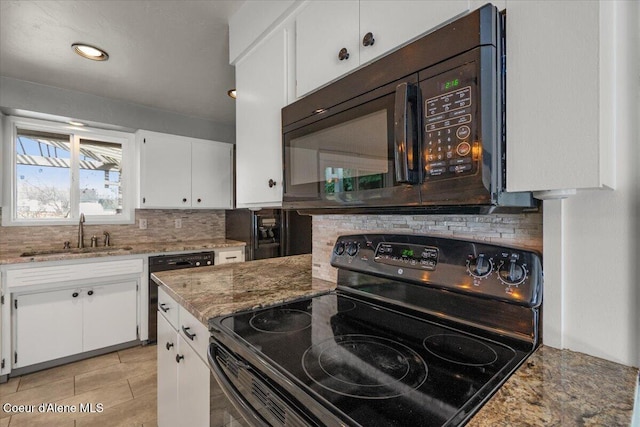 kitchen with a sink, backsplash, black appliances, and white cabinets