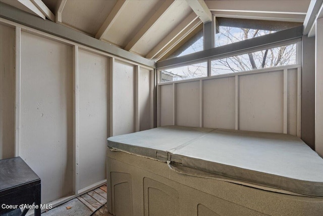 unfurnished sunroom with lofted ceiling with beams