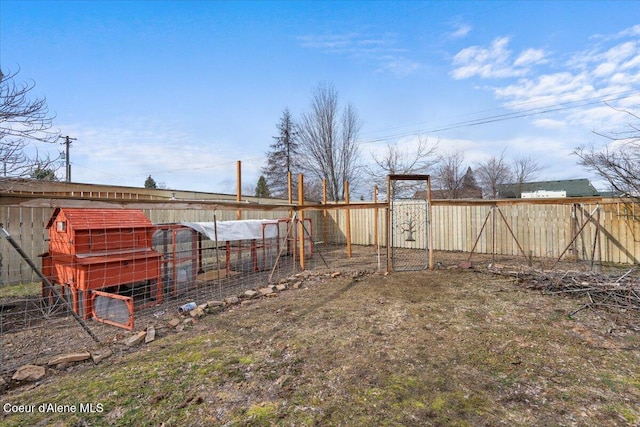 view of yard featuring an outbuilding, exterior structure, and fence