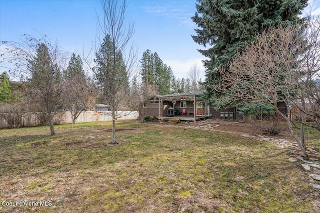 view of yard featuring a deck and fence