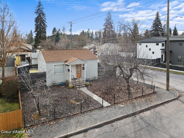 view of front of home featuring a vegetable garden and fence