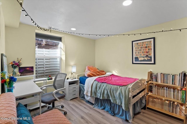 bedroom featuring recessed lighting, wood finished floors, and track lighting