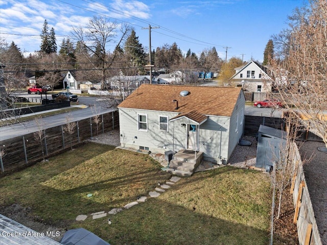 exterior space featuring a lawn and a fenced backyard