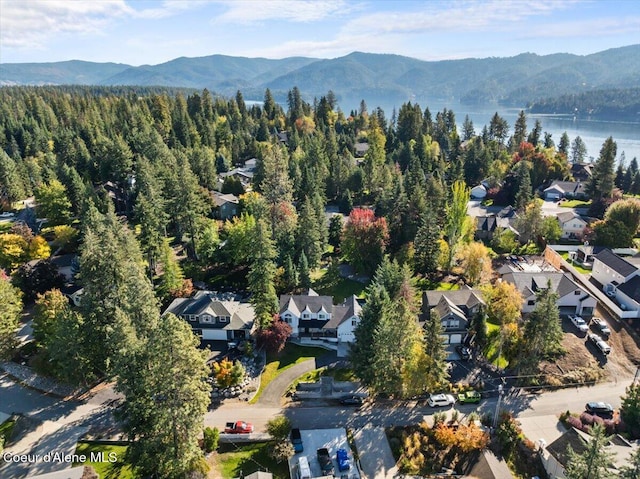 bird's eye view featuring a residential view, a forest view, and a water and mountain view