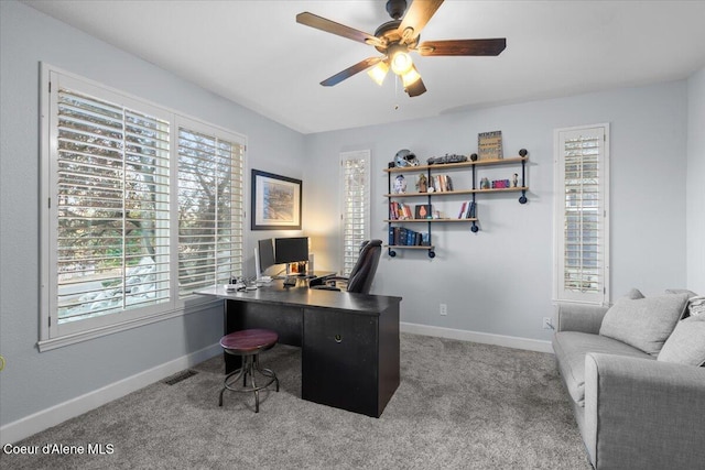 office area featuring a ceiling fan, carpet, visible vents, and baseboards