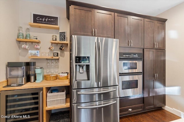 kitchen featuring dark brown cabinets, baseboards, wine cooler, appliances with stainless steel finishes, and dark wood-style flooring