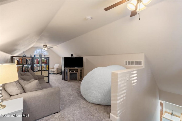 carpeted living area with lofted ceiling and visible vents