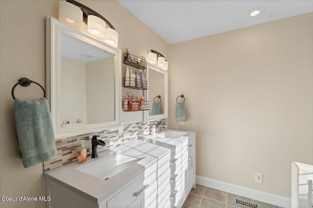 bathroom with a sink, backsplash, double vanity, and tile patterned flooring