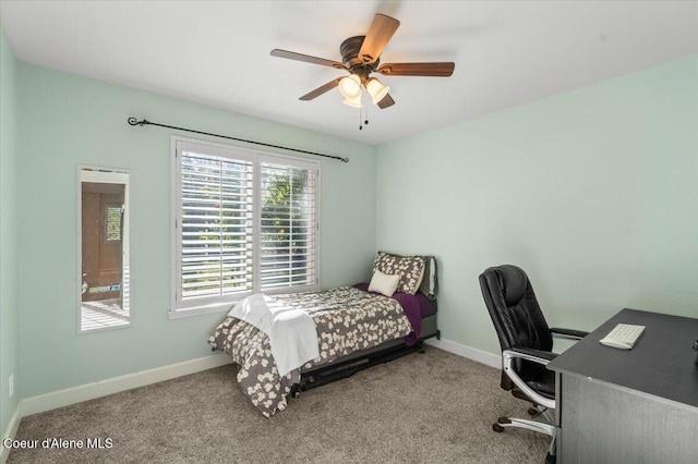 carpeted bedroom with baseboards and a ceiling fan