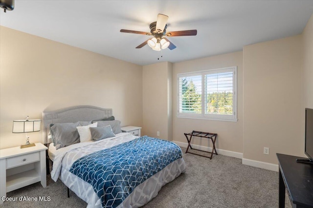 carpeted bedroom with a ceiling fan and baseboards