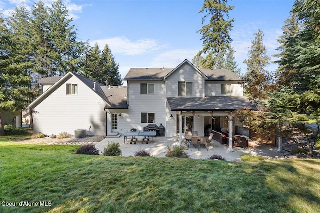 back of house featuring a patio area, central AC unit, and a yard