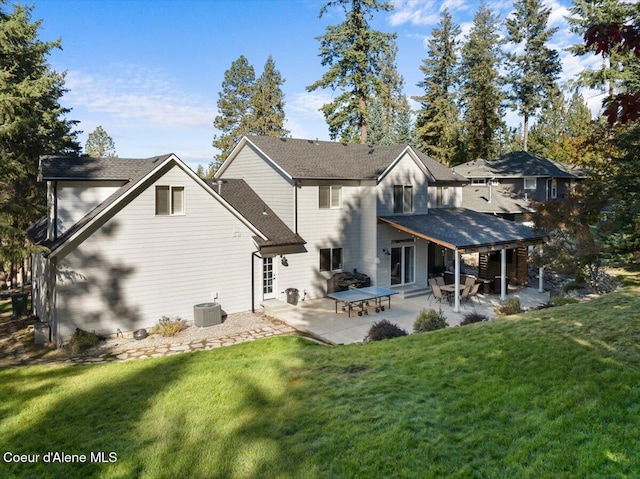 rear view of property featuring central air condition unit, a lawn, and a patio area