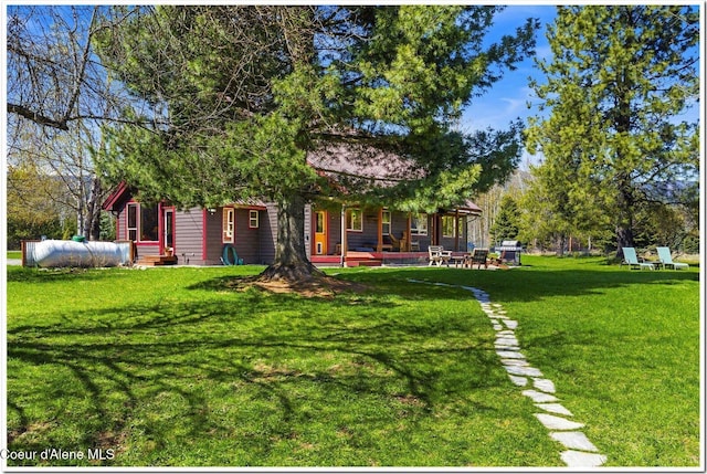 view of yard featuring covered porch