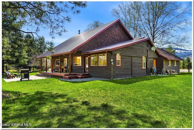 rear view of house with a yard and metal roof