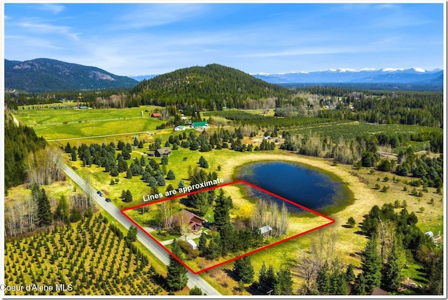 drone / aerial view featuring a rural view and a water and mountain view