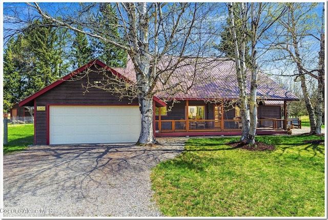 view of front facade with a porch, an attached garage, driveway, and a front yard