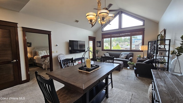 dining area featuring visible vents, light carpet, high vaulted ceiling, and an inviting chandelier