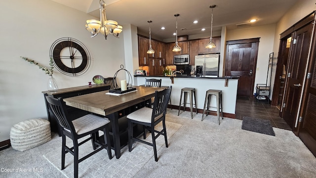 dining room featuring a notable chandelier, recessed lighting, light colored carpet, and baseboards