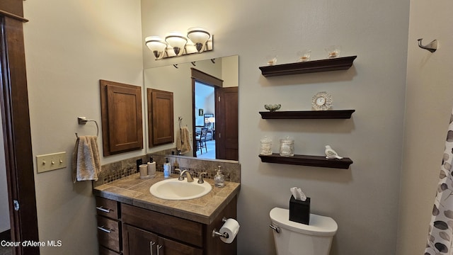 bathroom featuring toilet and vanity