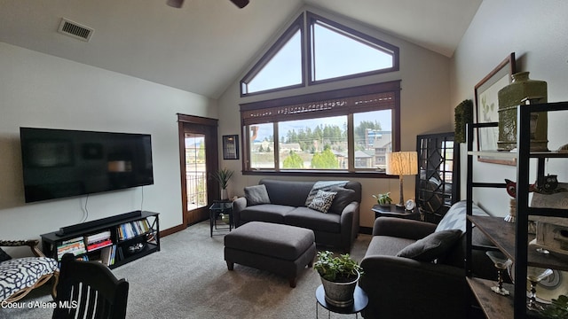 living area with visible vents, high vaulted ceiling, baseboards, and carpet floors