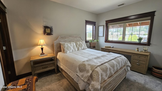 carpeted bedroom featuring visible vents