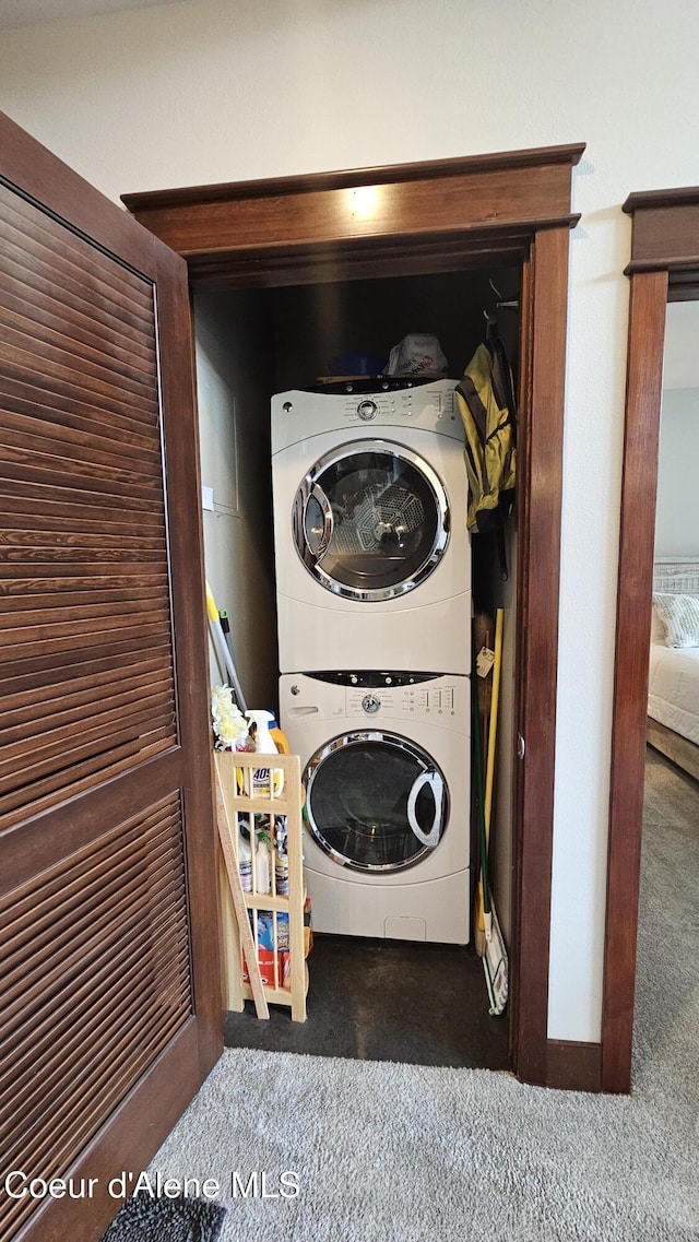 laundry room featuring laundry area and stacked washer / drying machine