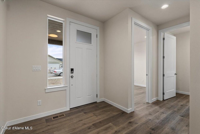 foyer entrance featuring visible vents, recessed lighting, baseboards, and dark wood-style flooring