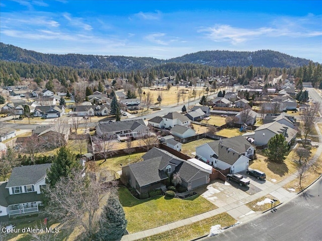 bird's eye view featuring a wooded view, a mountain view, and a residential view