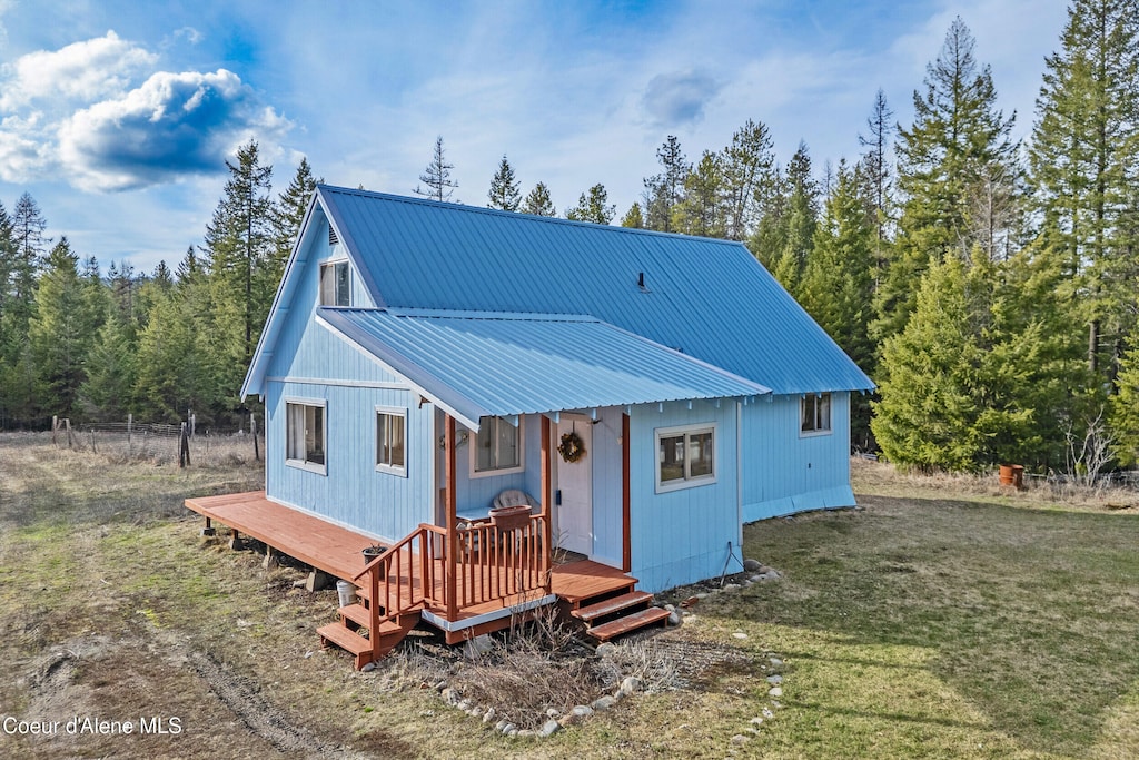 1920 W Settlement Rd, Priest River, ID 83856 - view of front of home with metal roof, a front lawn, and a deck