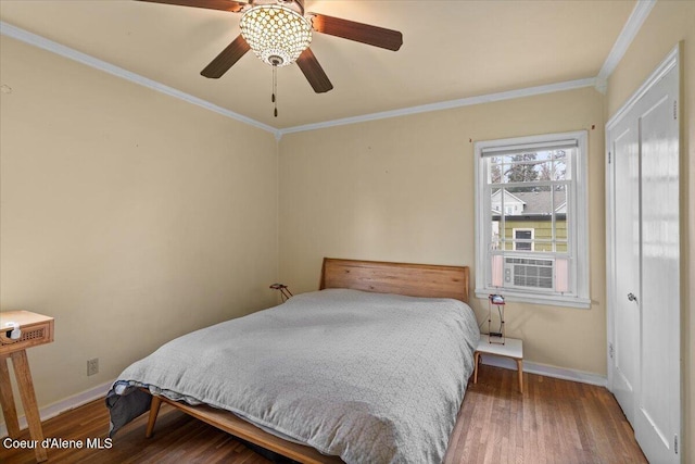 bedroom featuring ornamental molding, a ceiling fan, baseboards, and wood finished floors