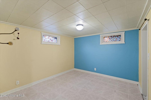 basement with crown molding and baseboards