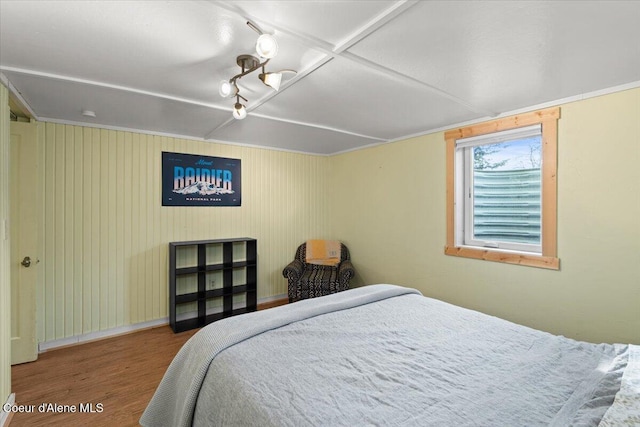 bedroom featuring baseboards and wood finished floors