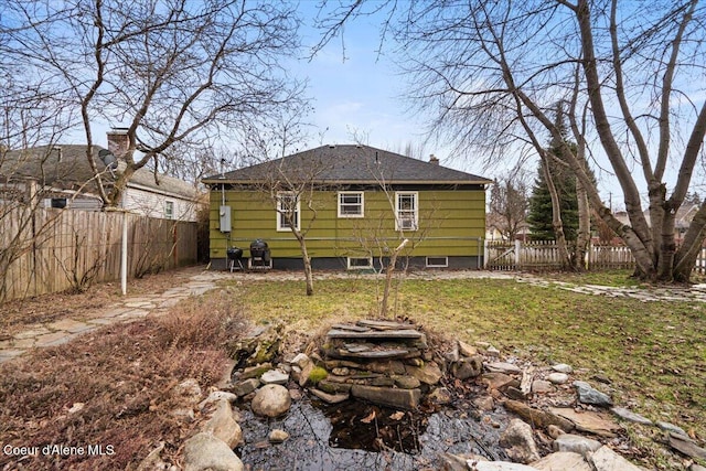 rear view of property with a fenced backyard